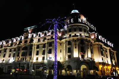 Low angle view of illuminated building at night