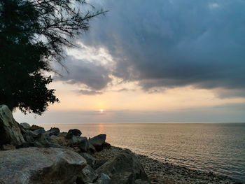 Scenic view of sea against sky at sunset