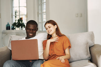 Couple sitting on sofa at home