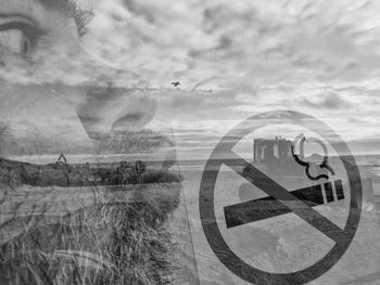 Digital composite image of sign on road against sky