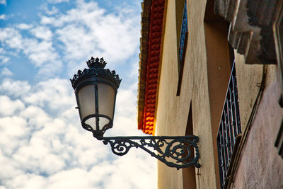 Low angle view of street light against building
