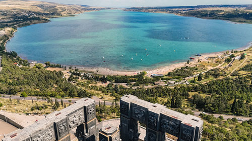 High angle view of buildings by sea