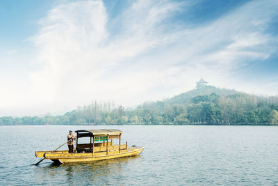 Boat in lake against sky