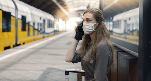 Full length of woman standing at railroad station