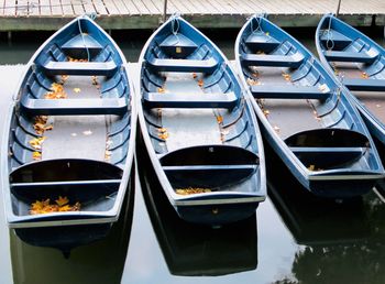 Close-up of boats moored in row