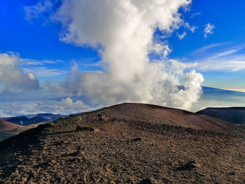 Panoramic view of volcanic landscape against blue sky