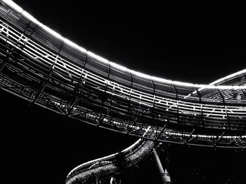 Low angle view of illuminated bridge against sky at night