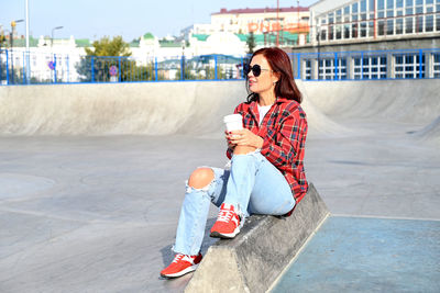 Portrait of young woman using mobile phone