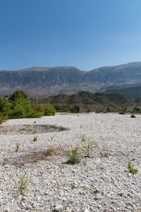 Scenic view of mountains against blue sky
