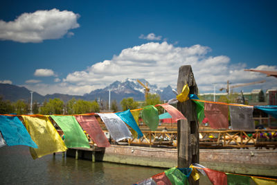 Multi colored prayer flags hanging against sky