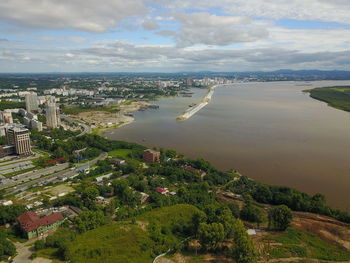 High angle view of buildings and trees against sky