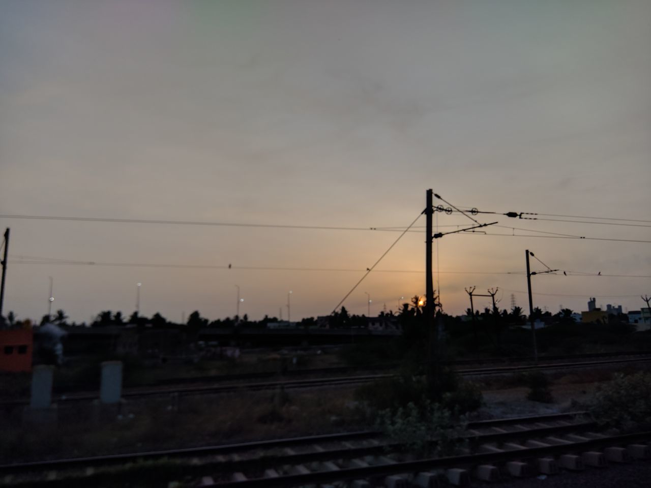 SILHOUETTE ELECTRICITY PYLONS AGAINST SKY DURING SUNSET