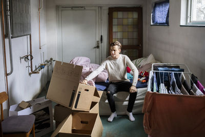 Man unpacking cardboard box in new home