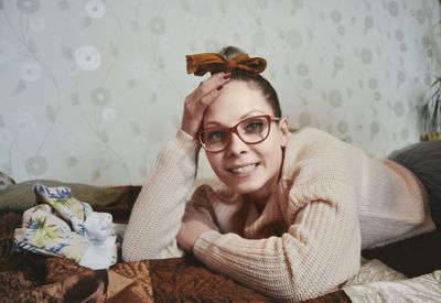 Portrait of young woman sitting at home