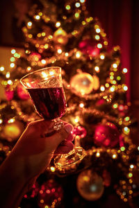 Cropped hand of woman holding christmas decorations