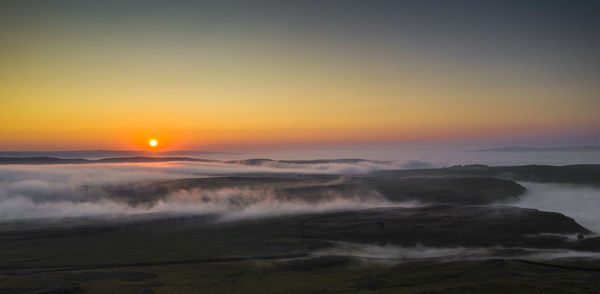 A aerial shot capturing a misty morning sunrise, malham, uk