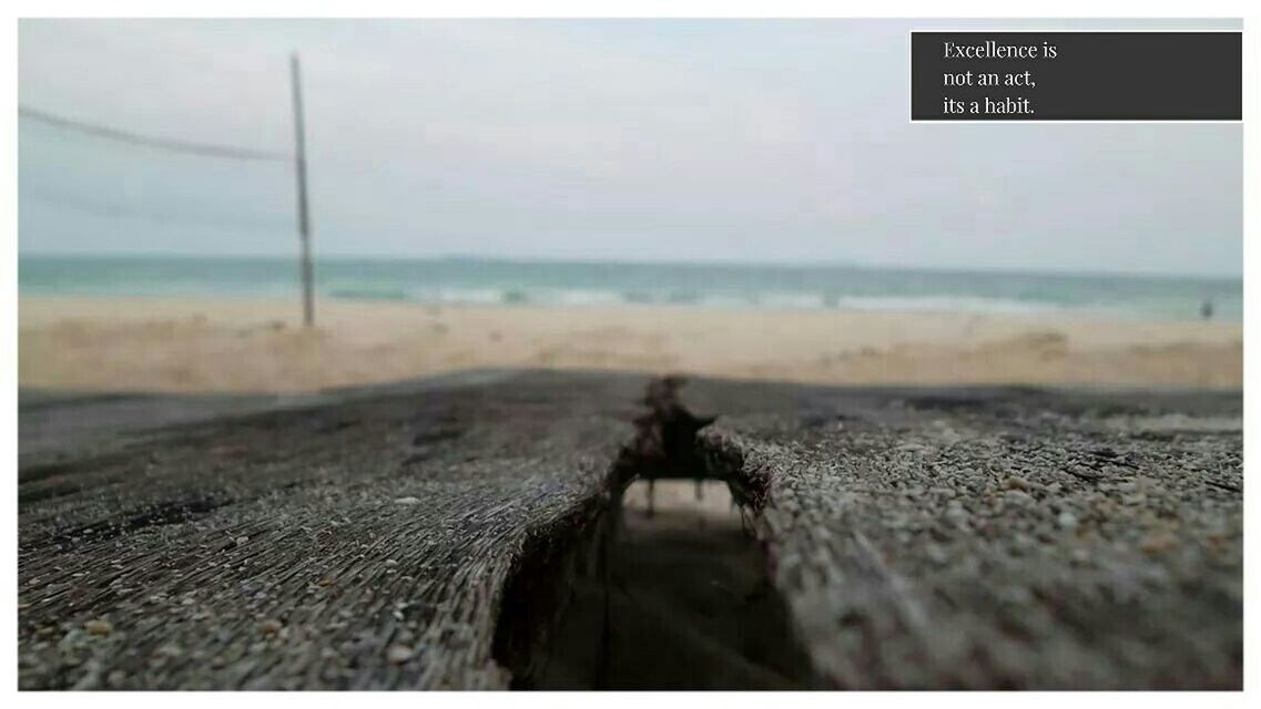 sea, beach, horizon over water, transfer print, water, shore, auto post production filter, sand, sky, selective focus, focus on foreground, text, tranquility, close-up, nature, tranquil scene, surface level, outdoors, transportation, no people