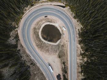 Aerial view of vehicles on road amidst trees