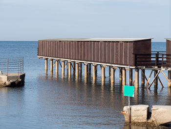 Wooden construction on stilts on the sea along the coast.