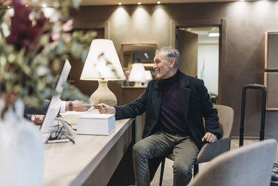 Man sitting on chair at table