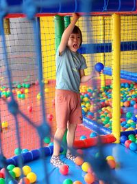 High angle view of young child standing in the indoor playground 