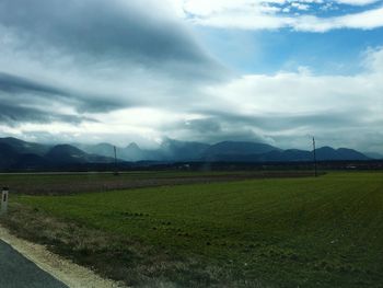 Scenic view of landscape against cloudy sky