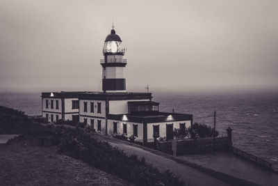 Lighthouse on building by sea