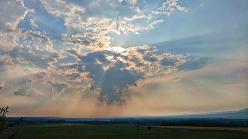 Scenic view of field against sky during sunset