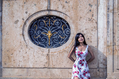 Woman standing against wall