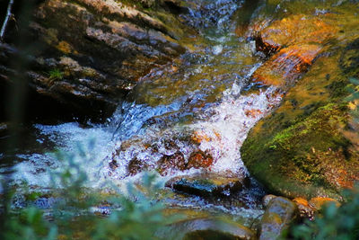 Close-up of waterfall on rock by river