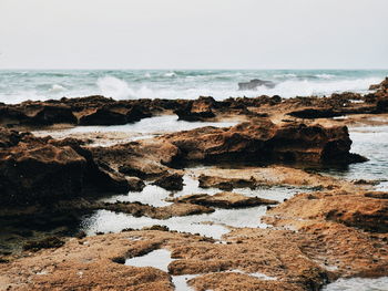 Scenic view of coast against sky