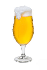 Close-up of beer glass against white background