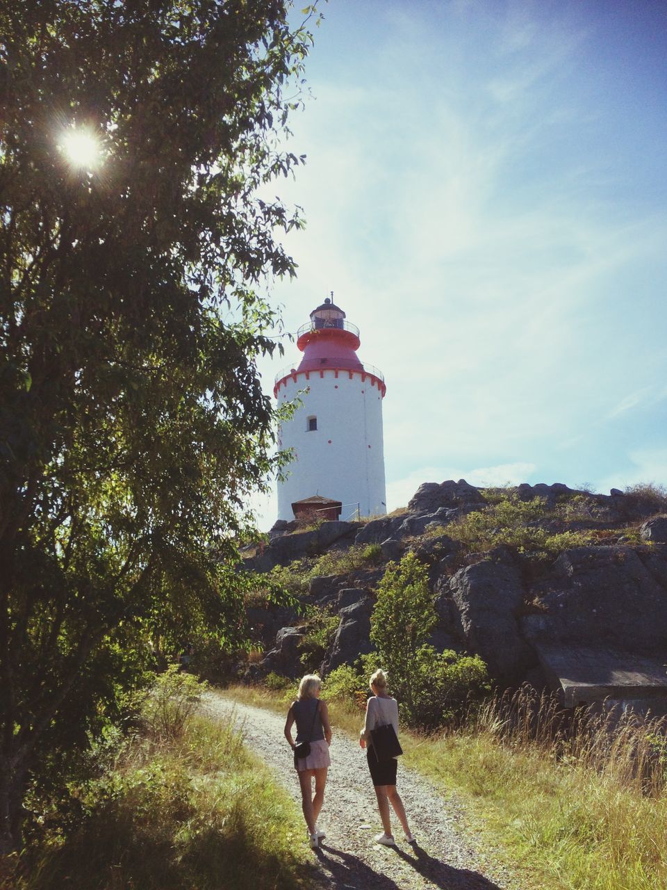 lighthouse, architecture, direction, guidance, built structure, nature, two people, building exterior, men, day, real people, grass, sky, women, outdoors, beauty in nature, people