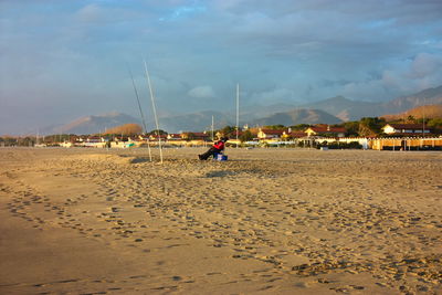 People on beach against sky