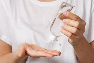 Midsection of man holding glass