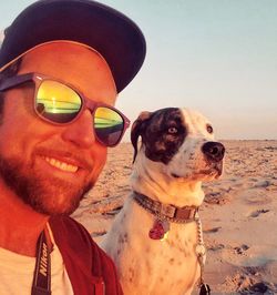 Portrait of dog with sunglasses on beach