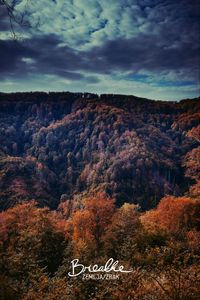 Scenic view of mountains against cloudy sky