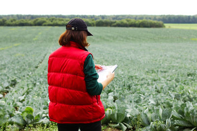 The farmer controls the quality of the cabbage crop. female agronomist in agriculture.