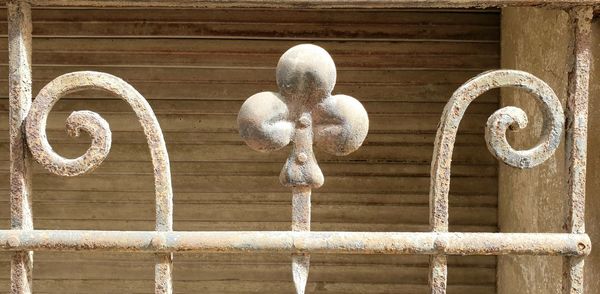 Close-up of white door knocker on wall