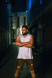 Portrait of young man standing at night