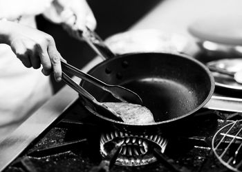 Close-up of person preparing food in kitchen