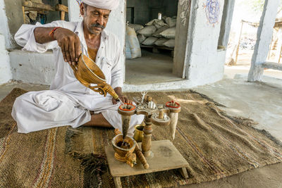 Man working at statue