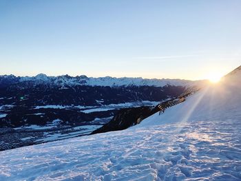 Scenic view of landscape against blue sky during winter