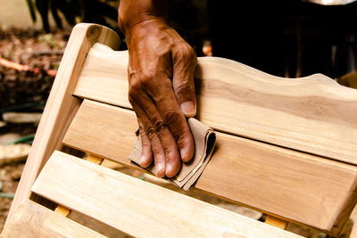 Close-up of hand working on wood