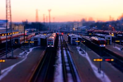 High angle view of illuminated railroad tracks against sky at sunset