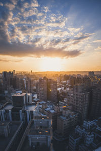 High angle view of buildings against sky during sunset