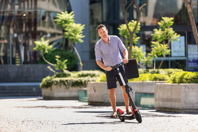 Full length of man on push scooter in baby