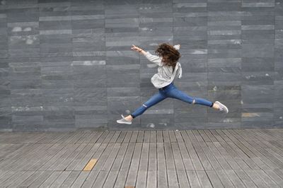 Full length of woman jumping in mid-air