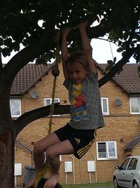 Full length of girl with arms raised against trees