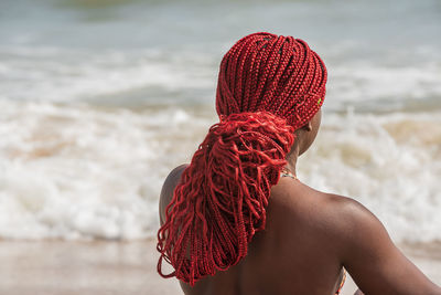 African woman on a beach with red hair in ghana west africa